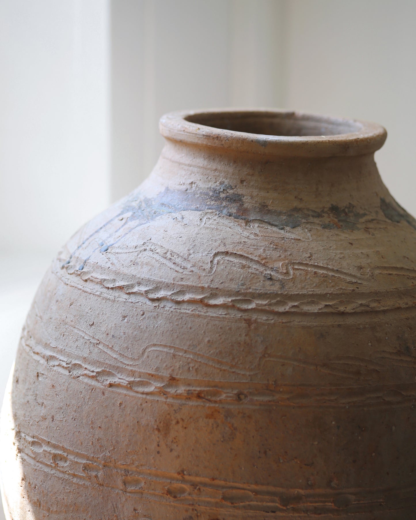 Close up of hand-thumbed artisan decorative detail on large Turkish terracotta pot