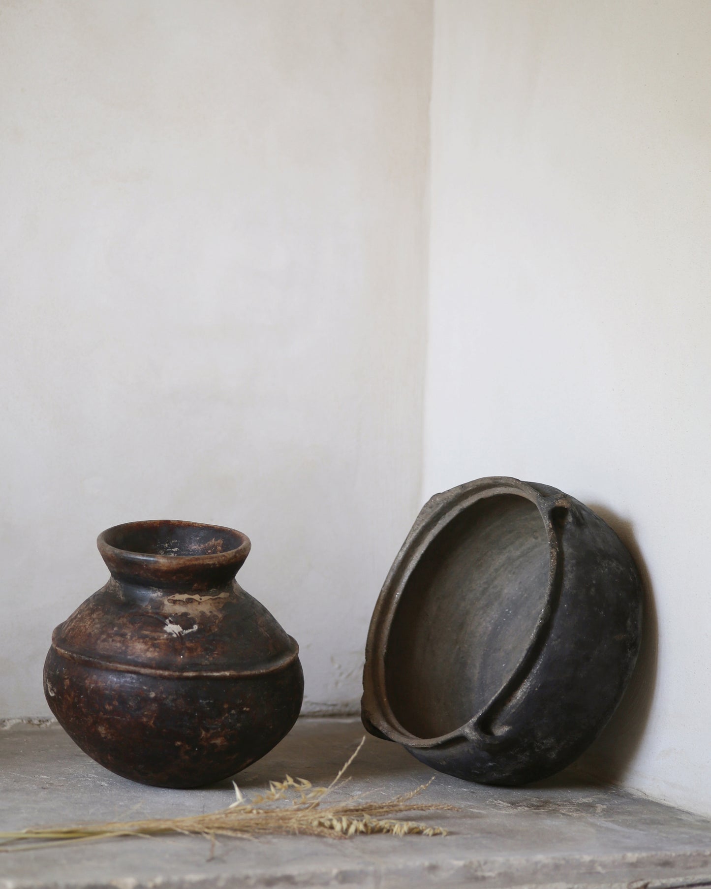 Antique African pot and Turkish clay bowl on old flagstone floor