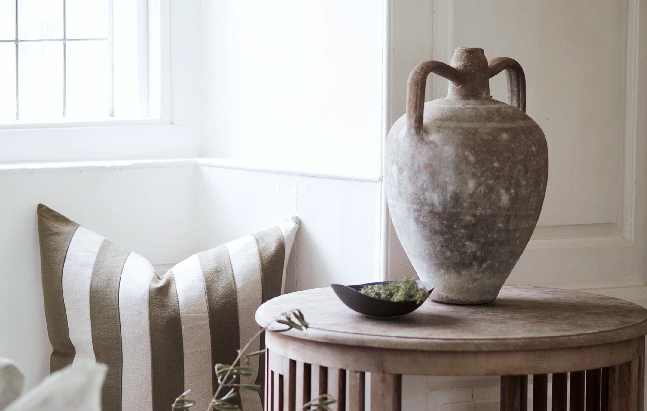 Decorative pottery styled on antique side table in farmhouse