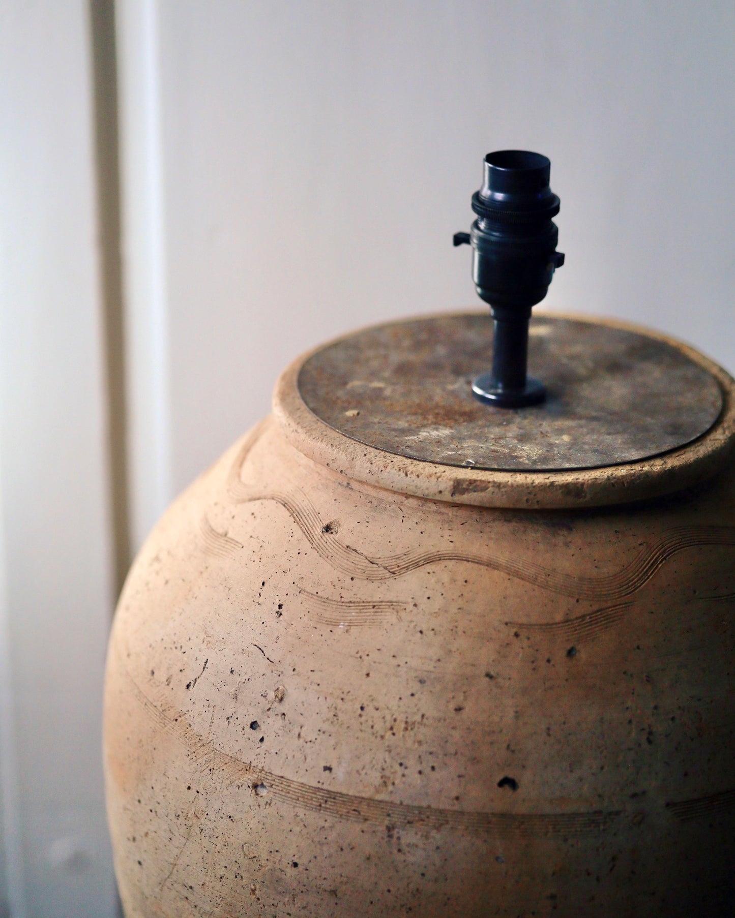 Rustic brass lamp fittings on natural clay lamp base