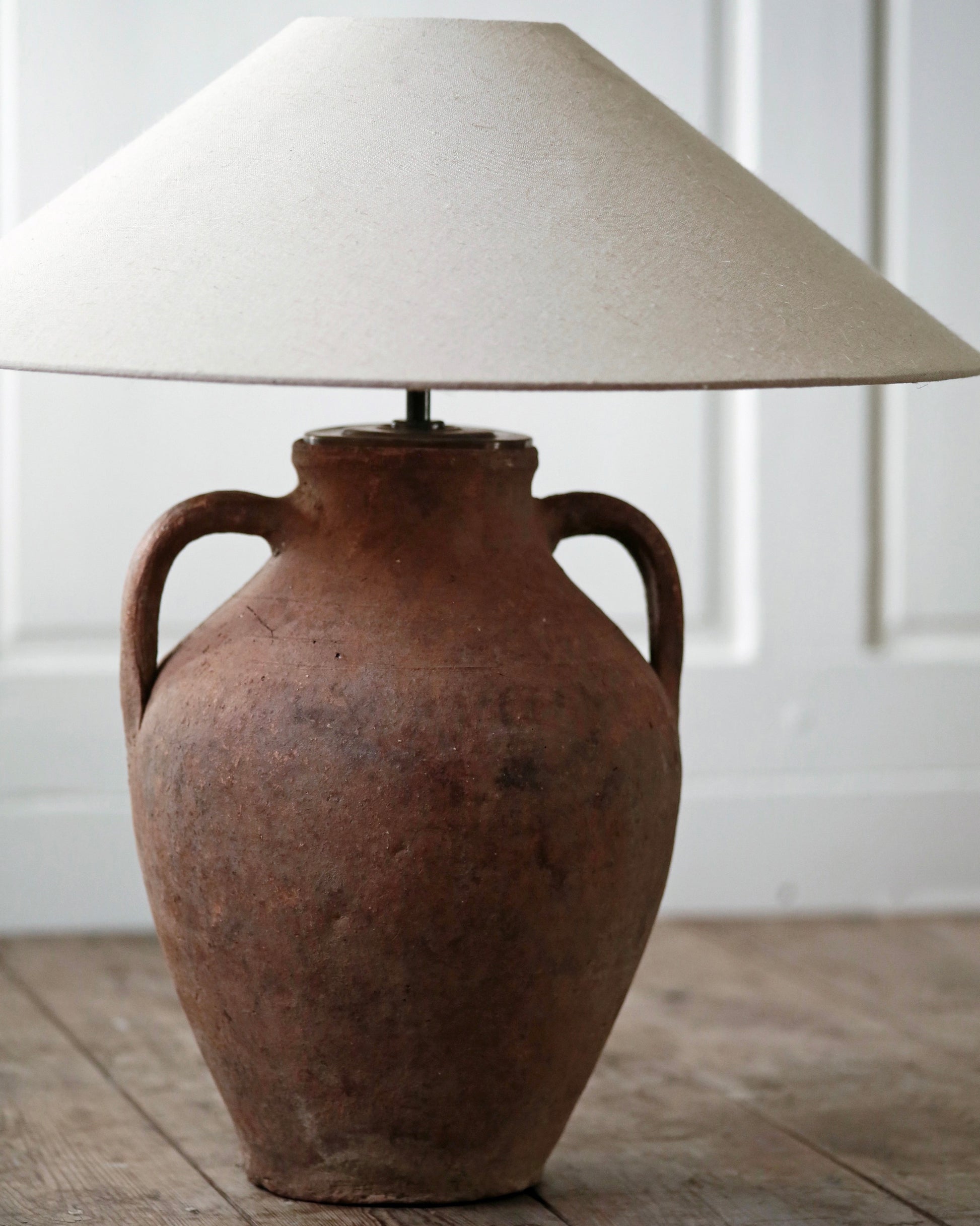 Rustic brown terracotta pot with handles converted to lamp