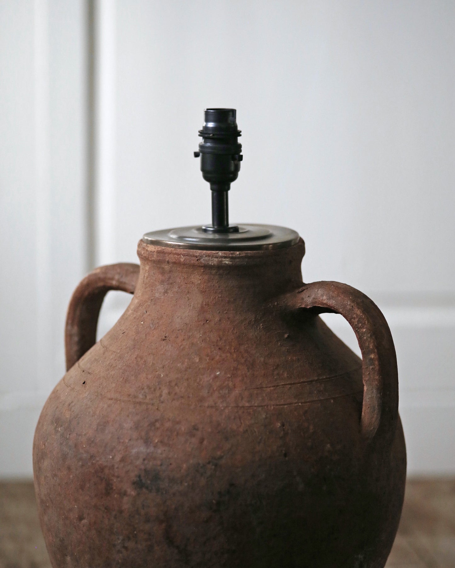 Brass lamp fittings on antique amphora