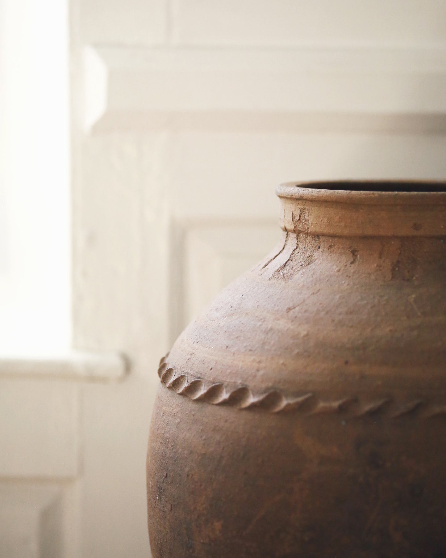 Rim detail of dark brown terracotta garden pot