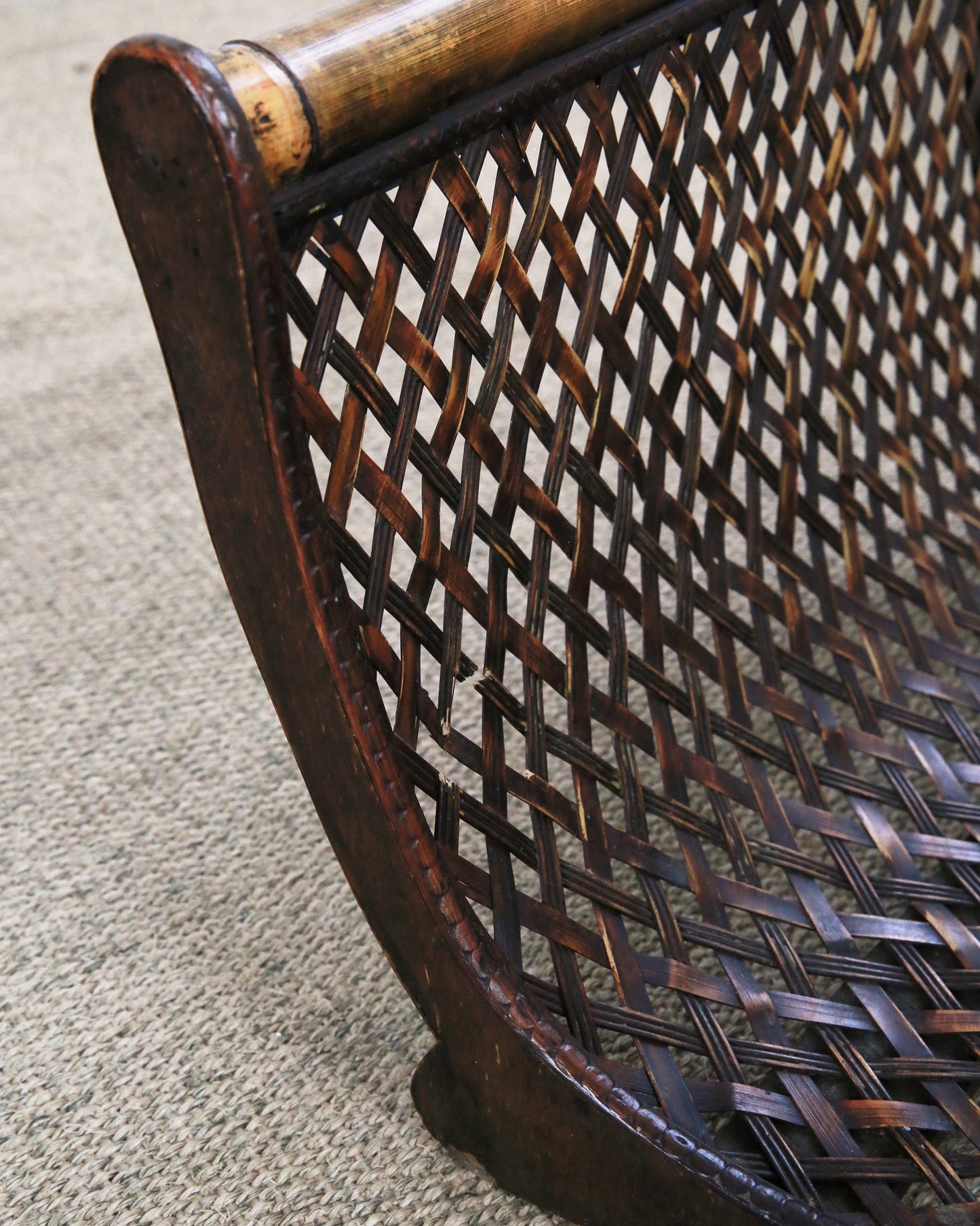 Close up of vintage dark wooden and bamboo magazine rack