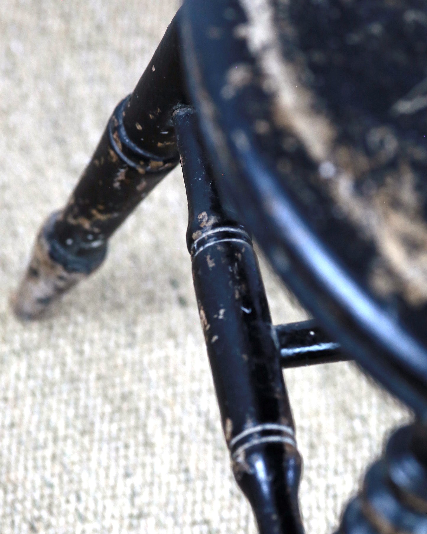 Detail of natural wear to vintage black chair
