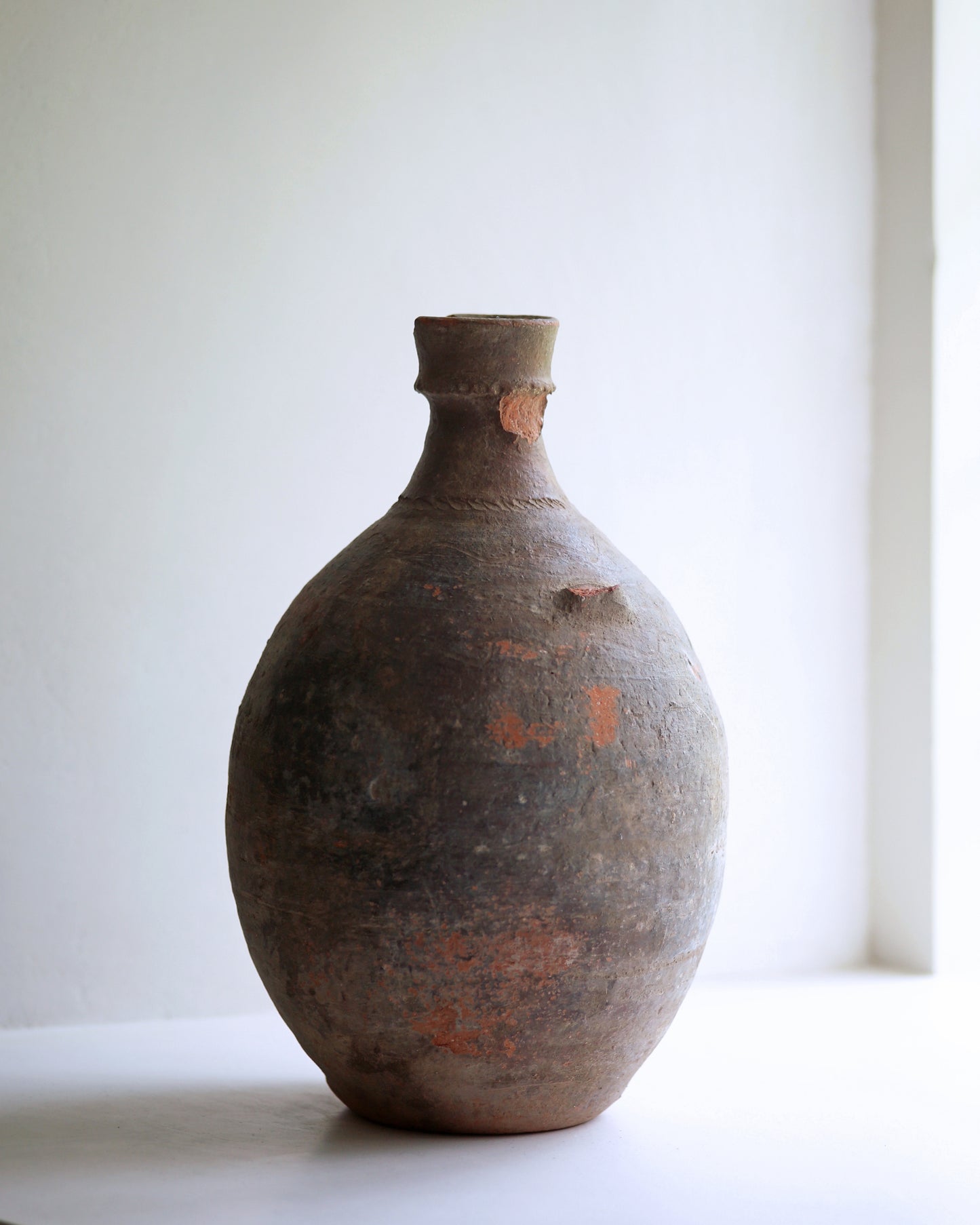 Signs of wear on old clay amphora missing handle