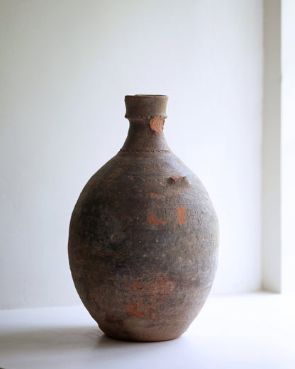 Signs of wear on old clay amphora missing handle