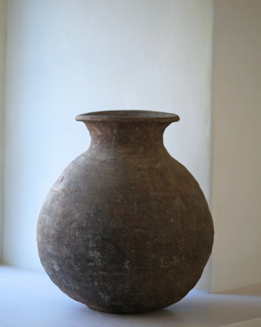 Dark wabi-sabi antique vessel