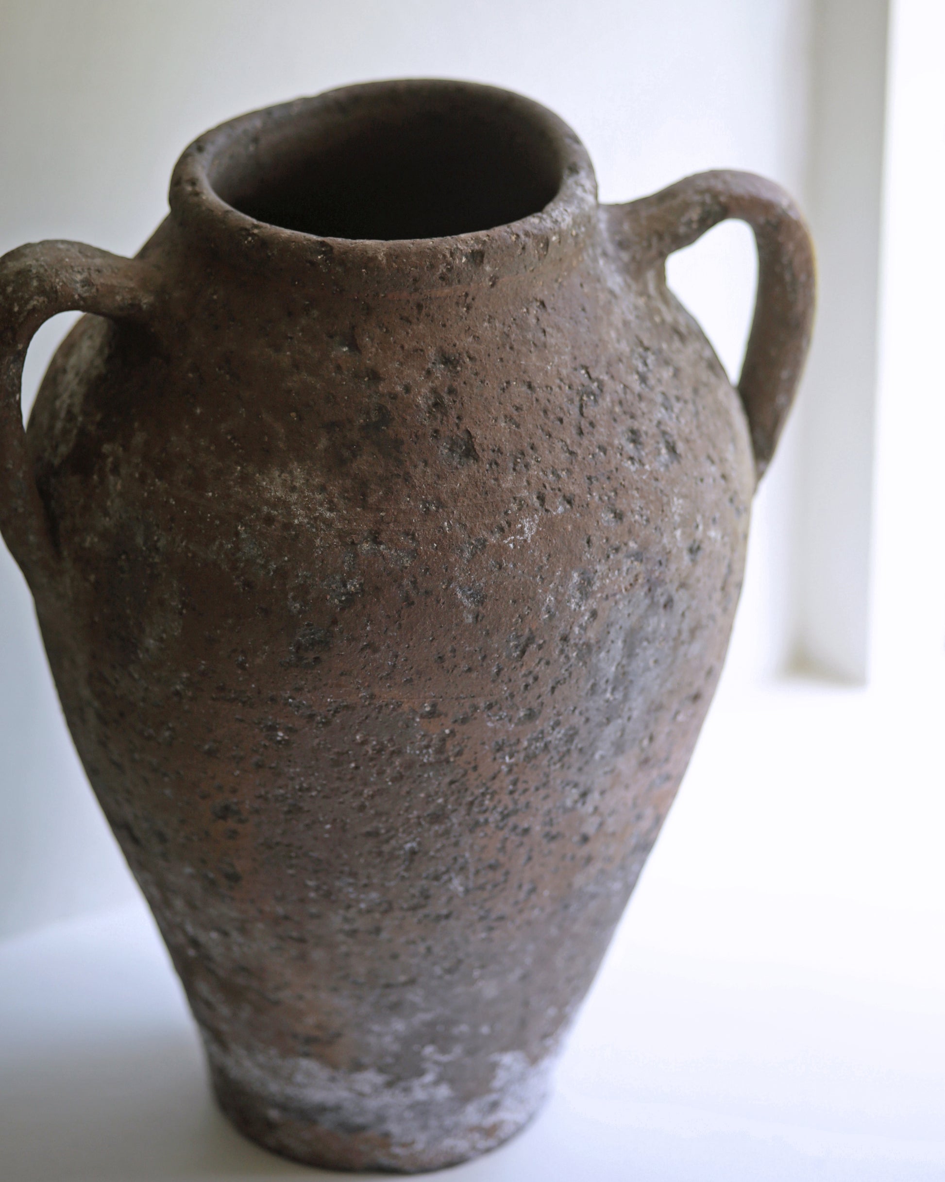 Close up of rustic textured terracotta clay pot and original hand thrown imperfections