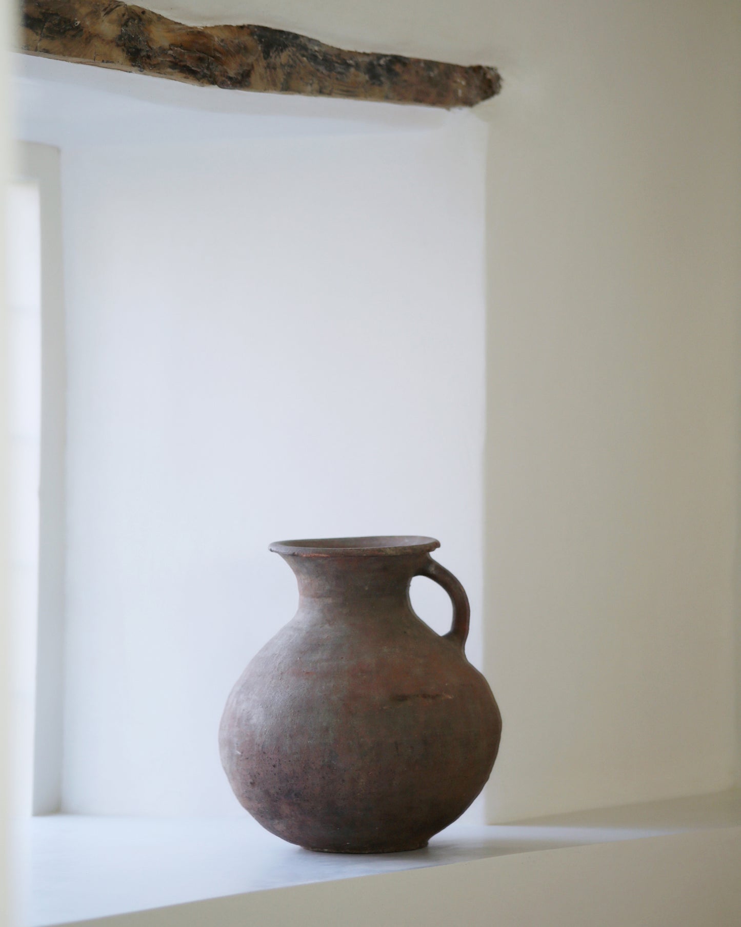 Farmhouse window sill decorated with antique clay pottery