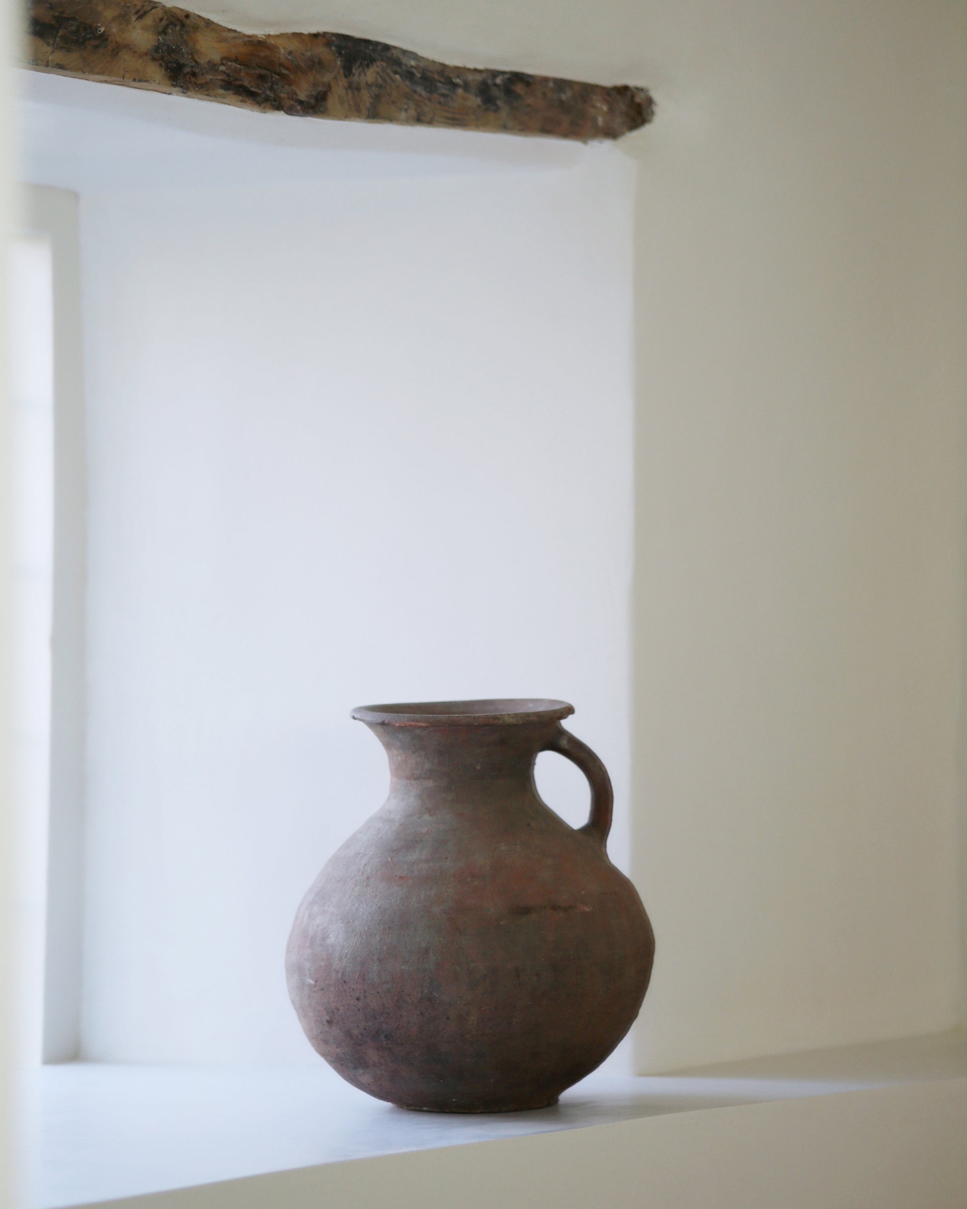 Farmhouse window sill decorated with antique clay pottery