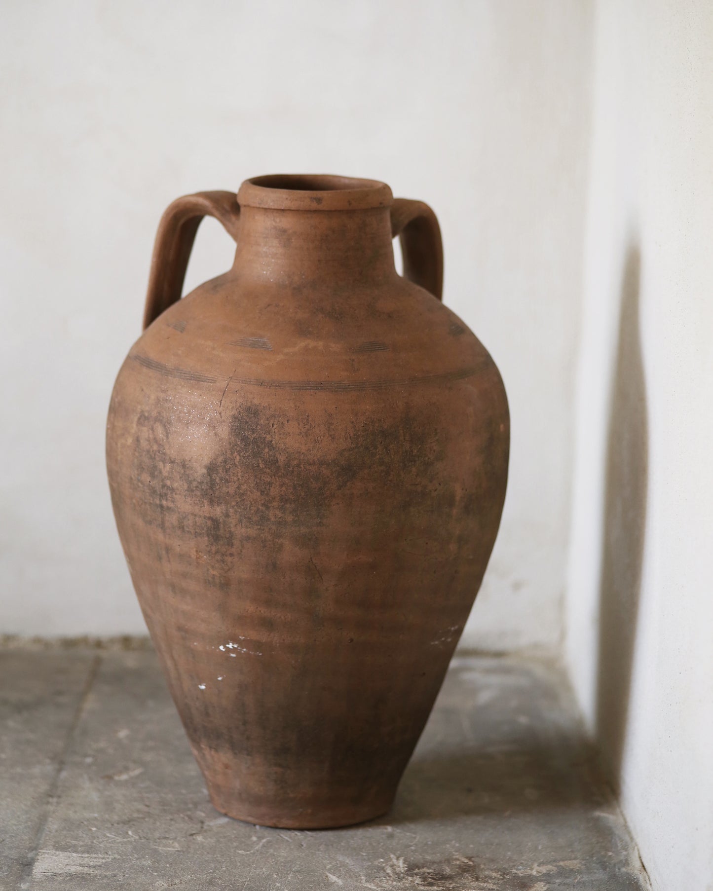 Back of a traditional antique amphora jar with textured surface 