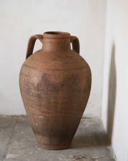 Back of a traditional antique amphora jar with textured surface 