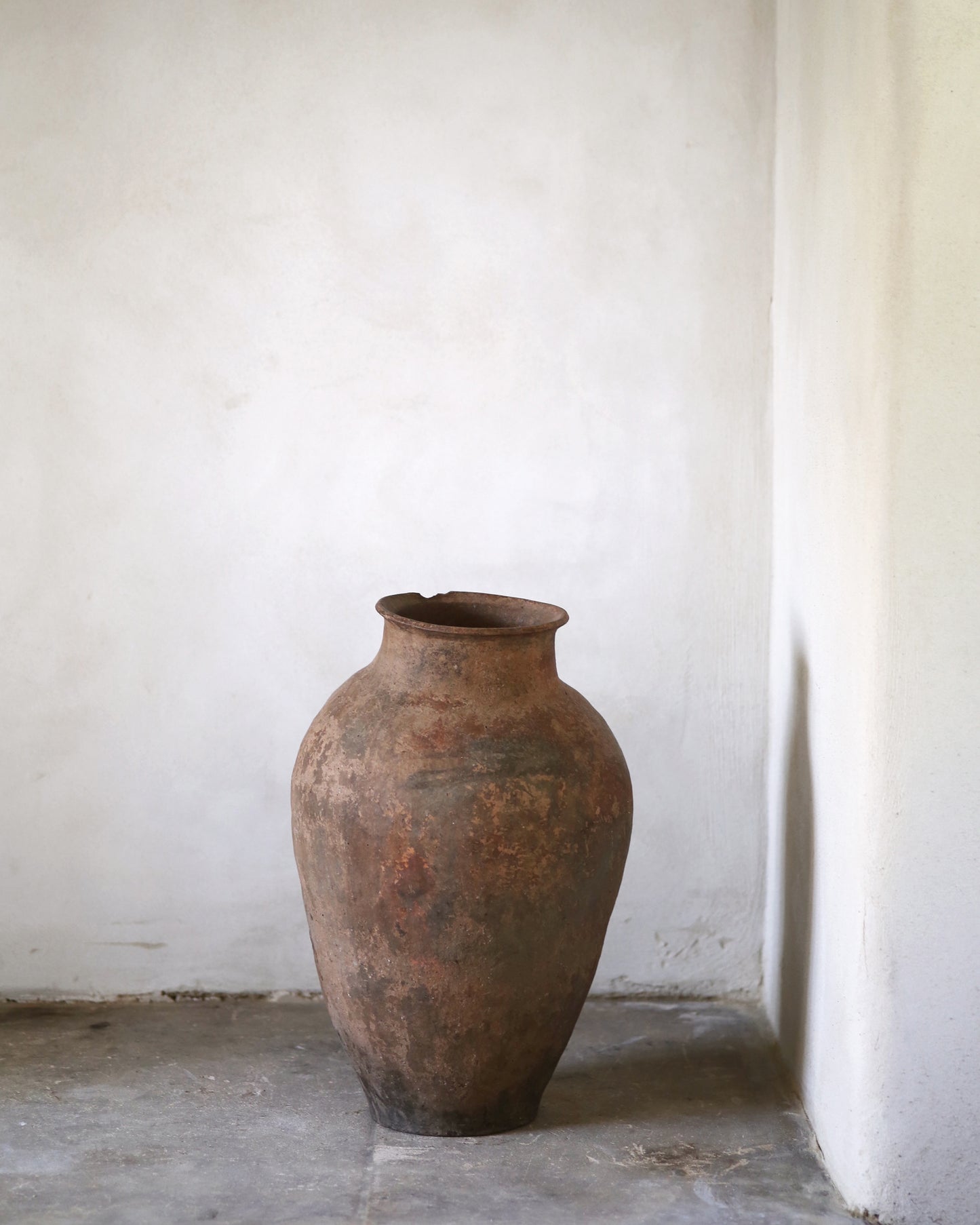 Vintage terracotta pot against a white wall
