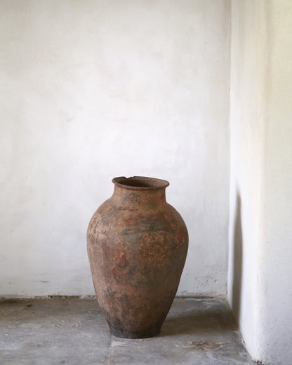 Vintage terracotta pot against a white wall