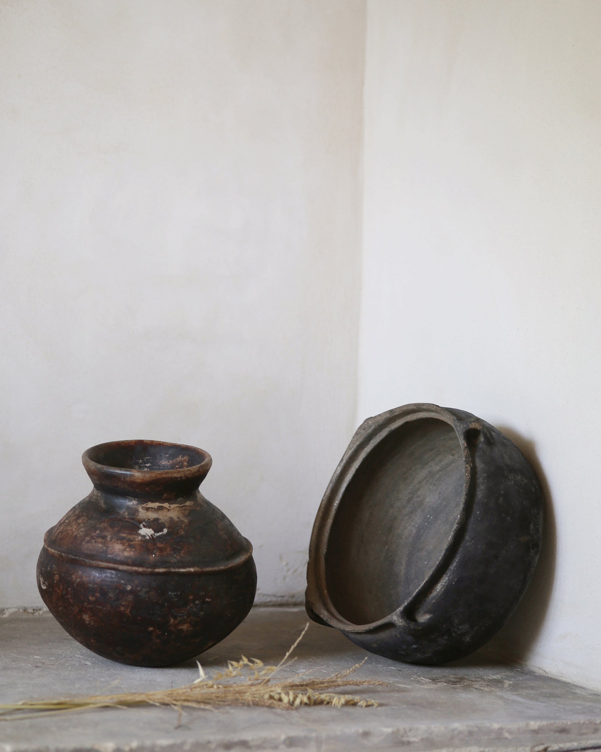 Antique African pot and Turkish clay bowl on old flagstone floor