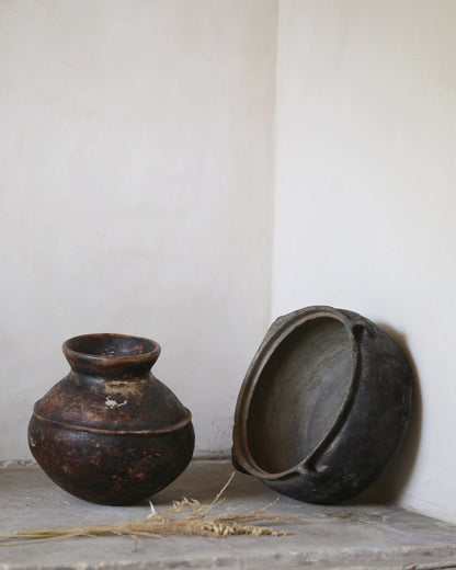 Antique African pot and Turkish clay bowl on old flagstone floor