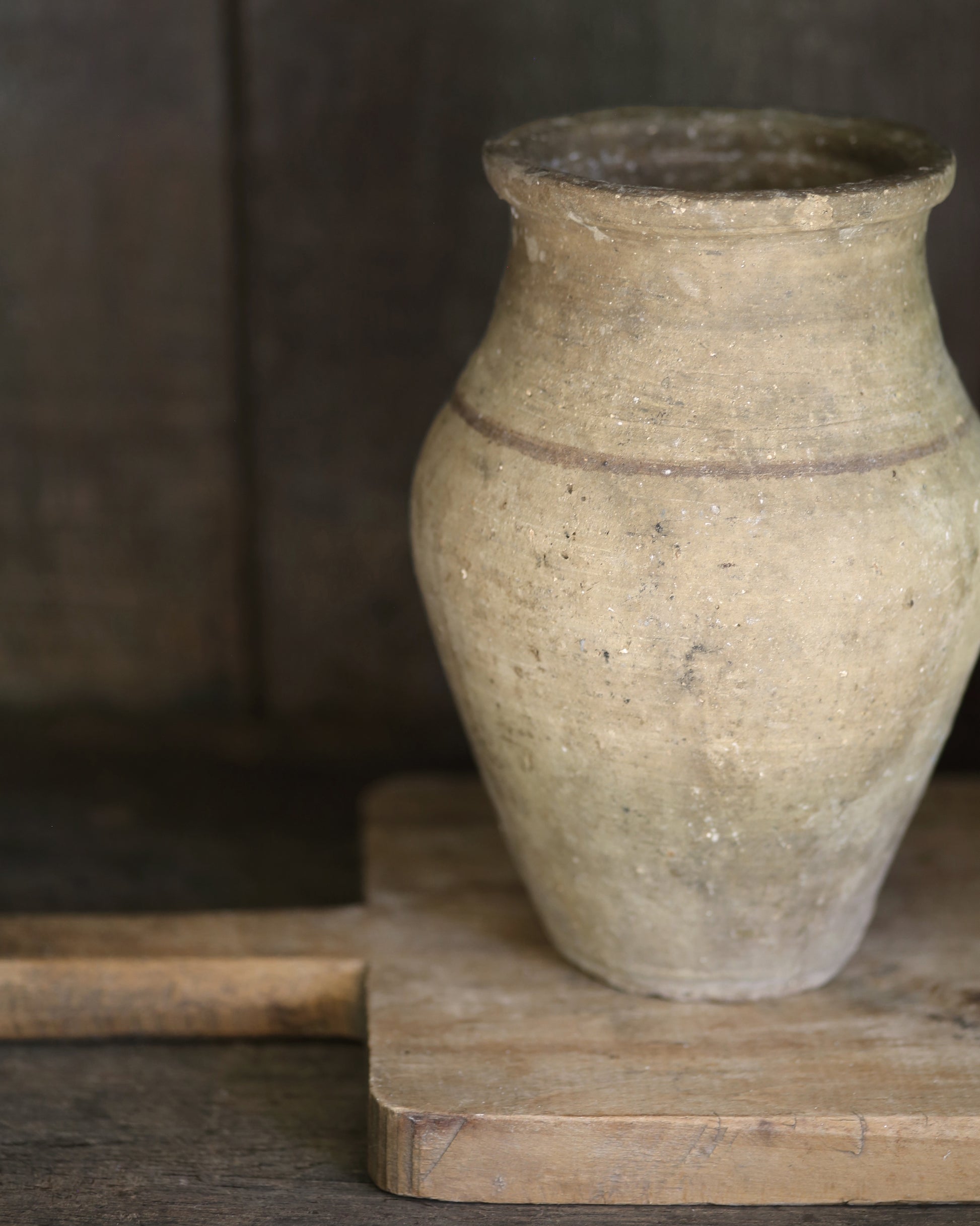 Vintage terracotta pot on a vintage wooden breadboard