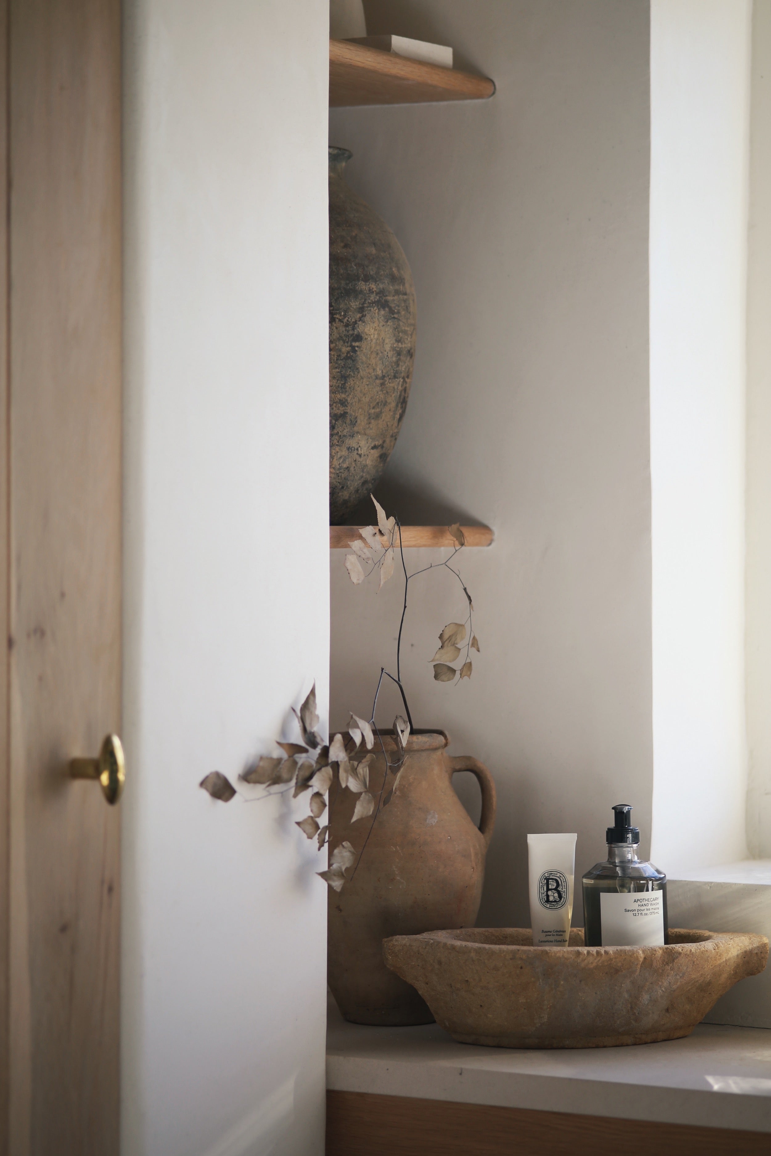 Neutral natural farmhouse interior styled with decorative unique clay pottery