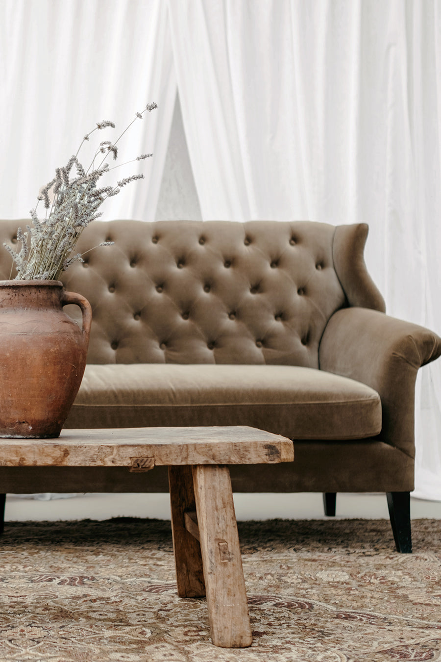 Old pot styled on vintage elm coffee table as prop styling at a wedding antique-style seating area