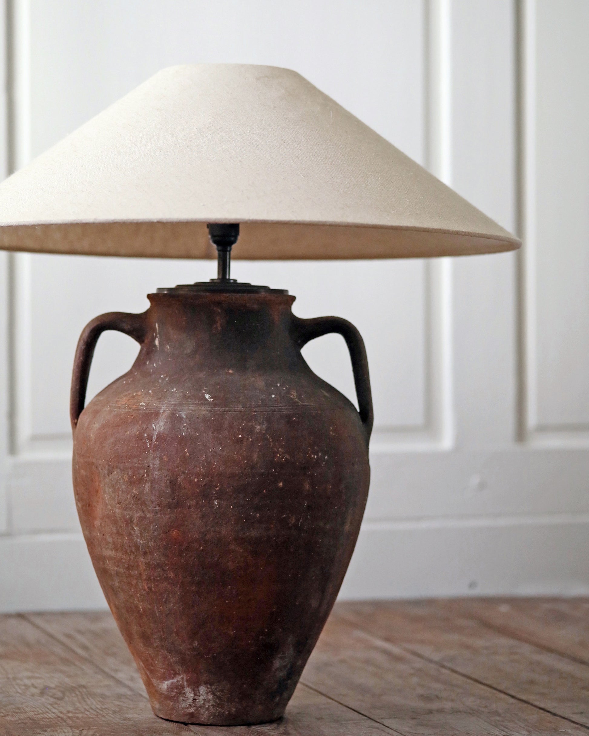 Rich terracotta toned clay lamp 
