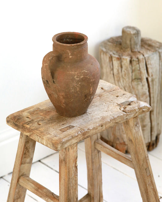 Rustic pitcher pot displayed on wooden elm stool