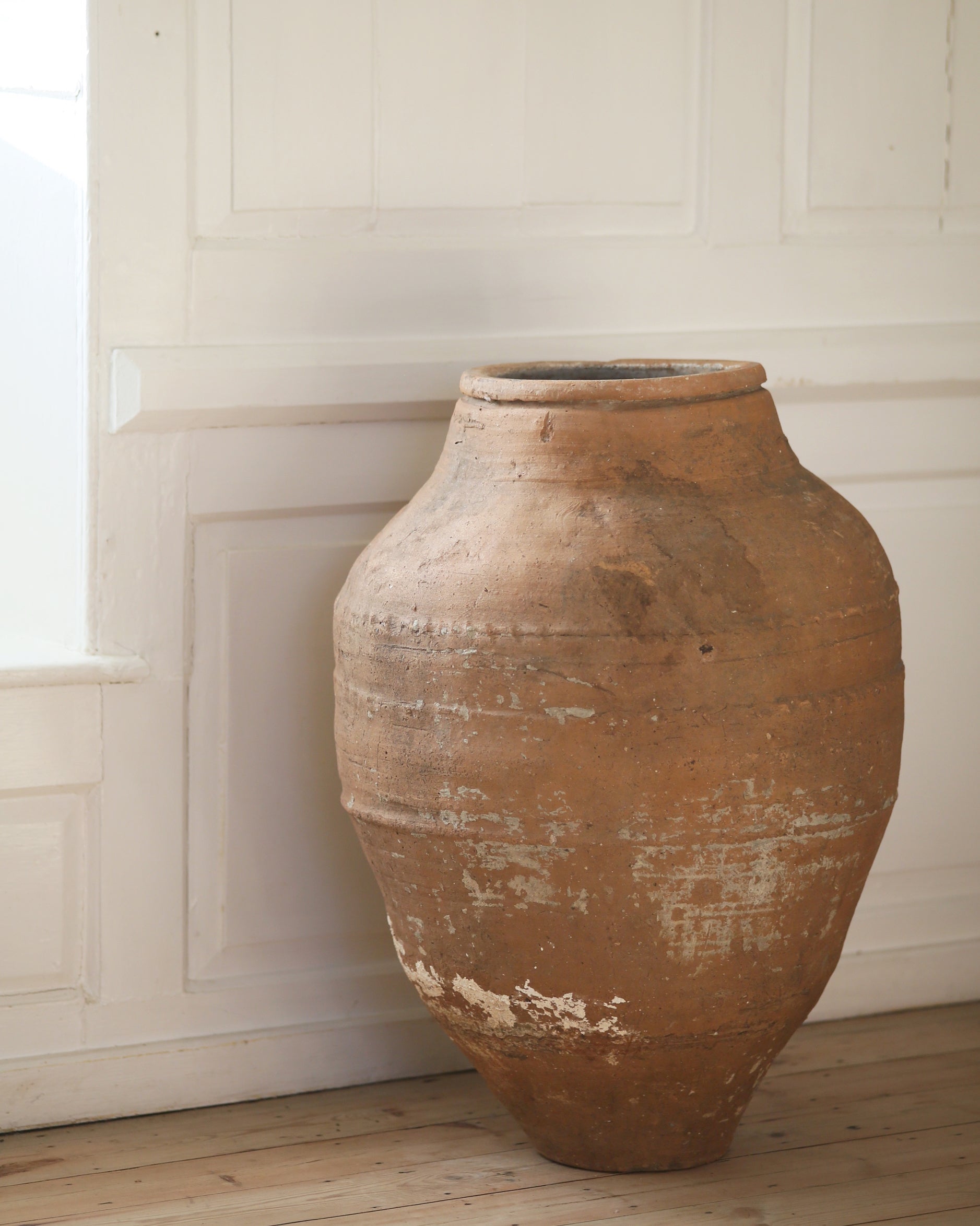 Aged antique terracotta pot originally for olive oil