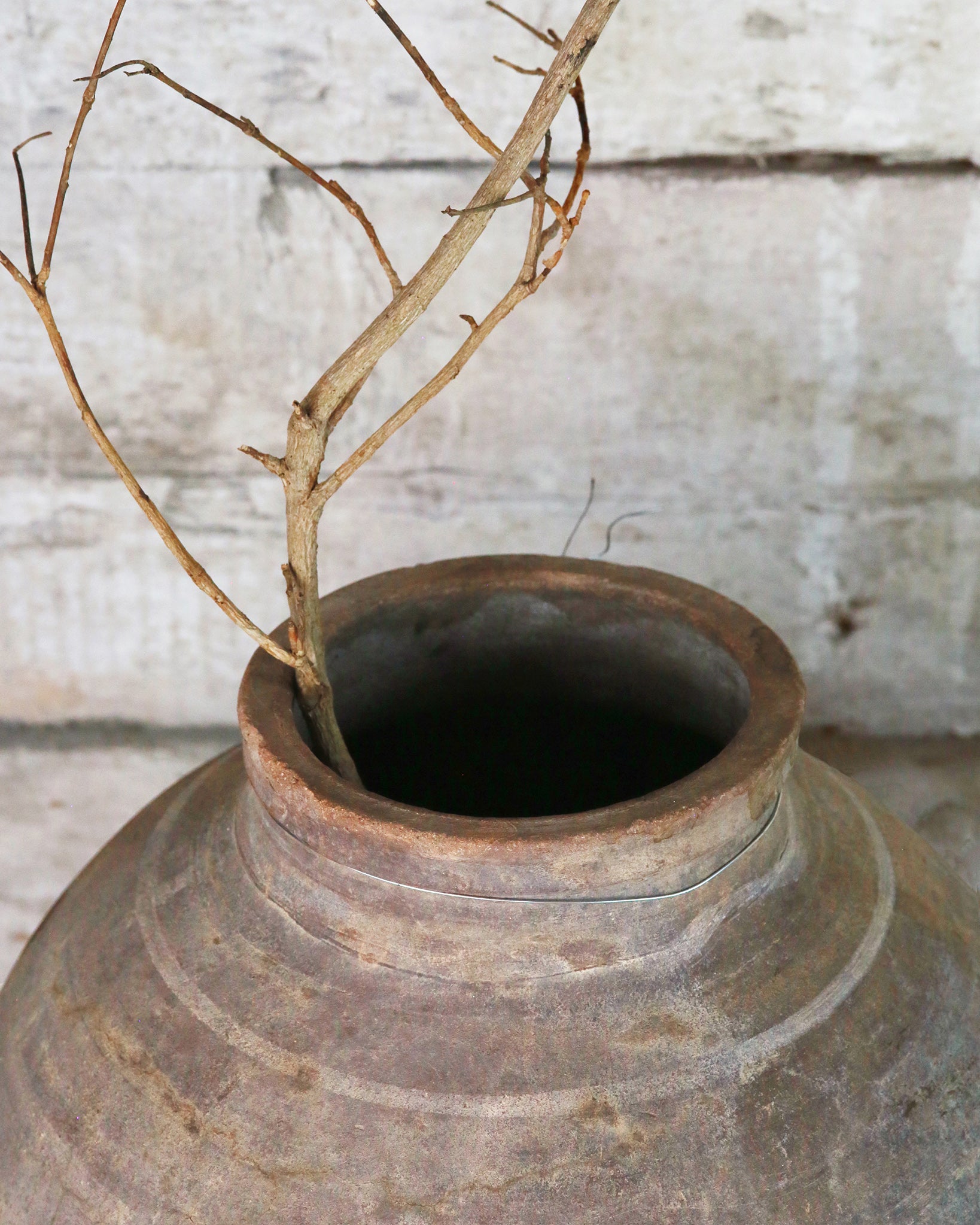 Rustic olive pot styled with branch