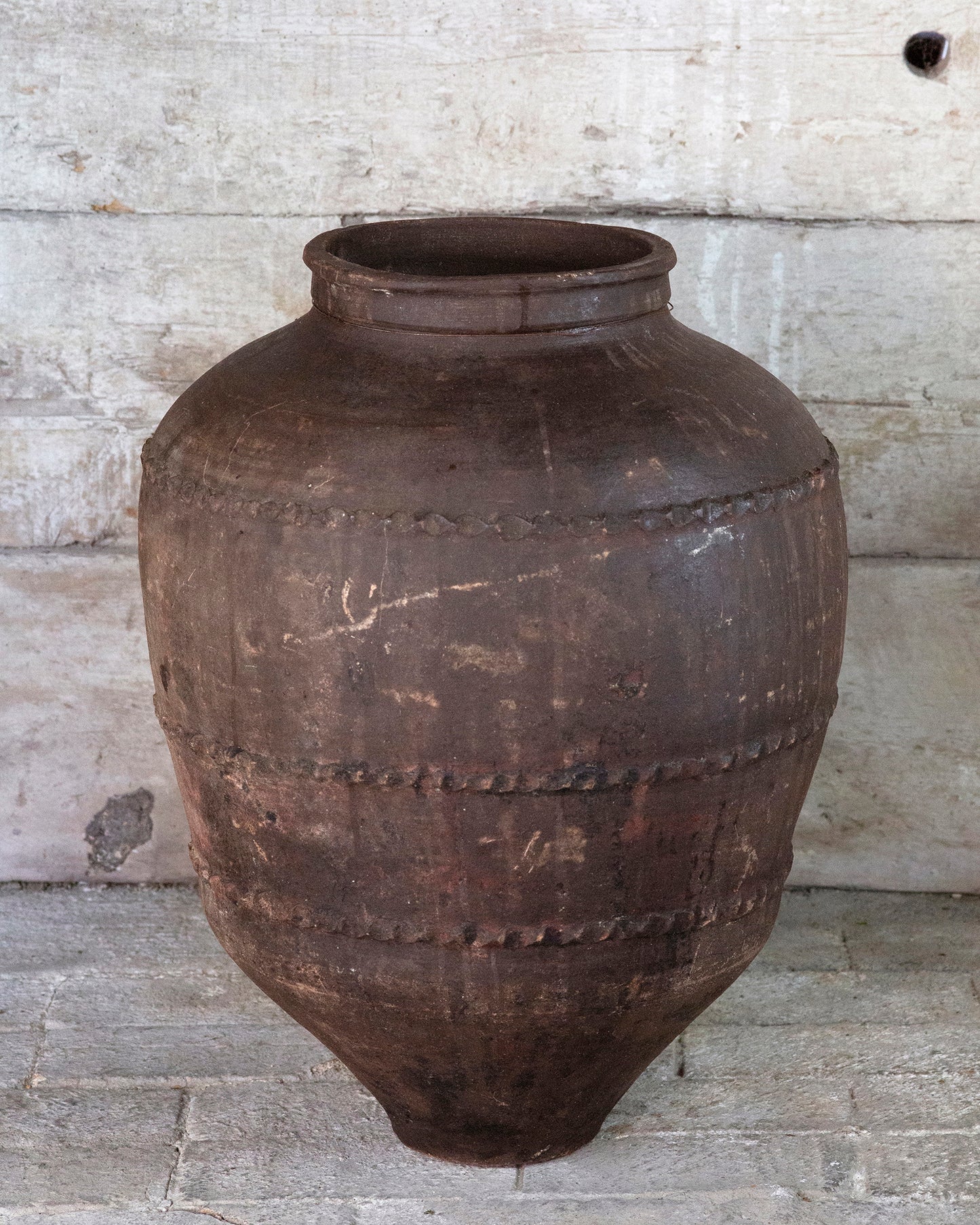 Detailed patina finish of dark Mediterranean olive pot