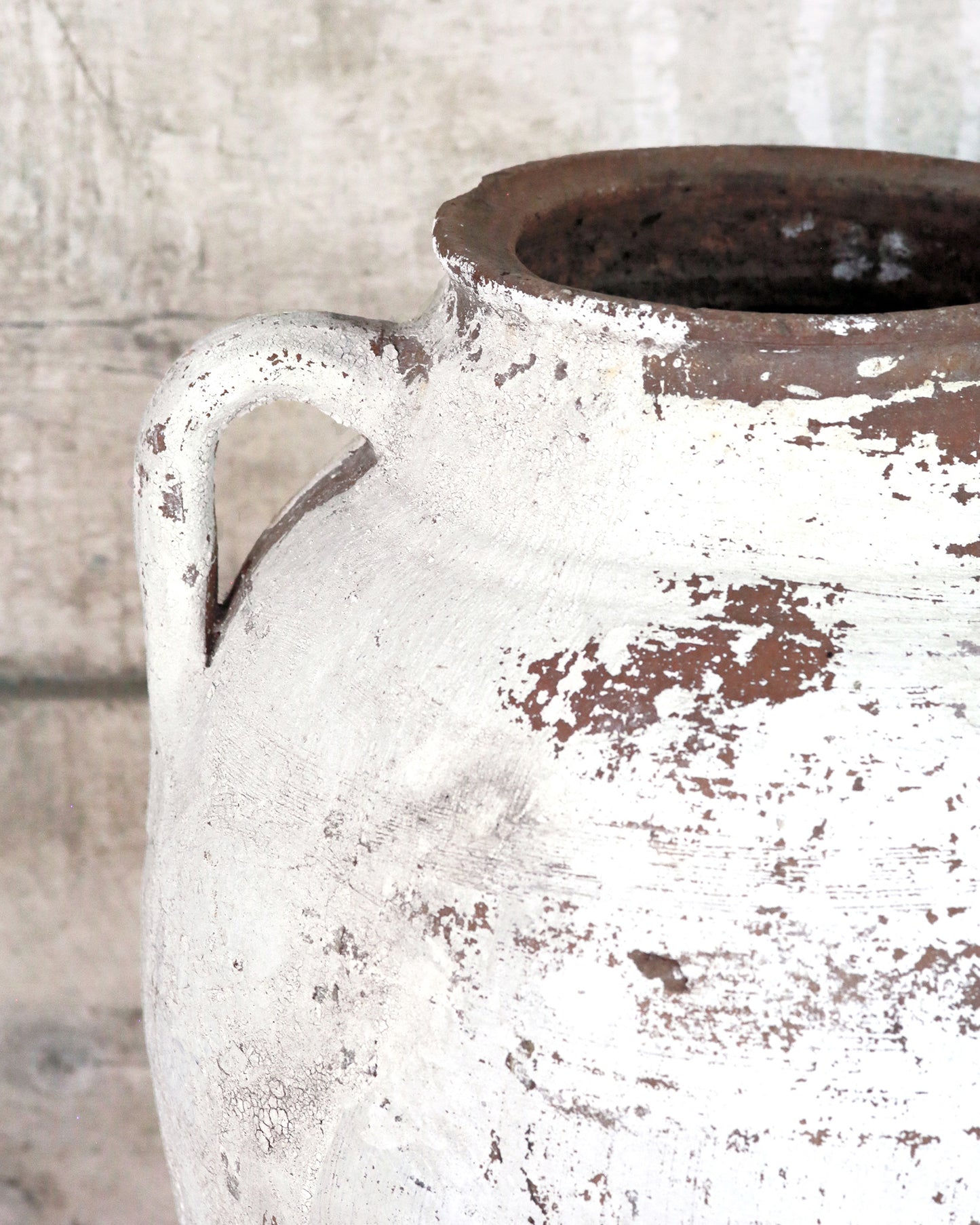 Flaked detail of white painted finish to Mediterranean olive pot