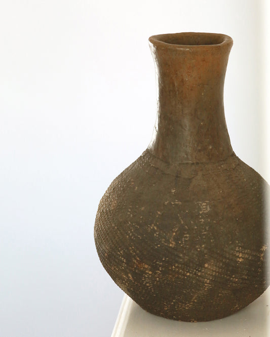 Antique African textured vase on mantel