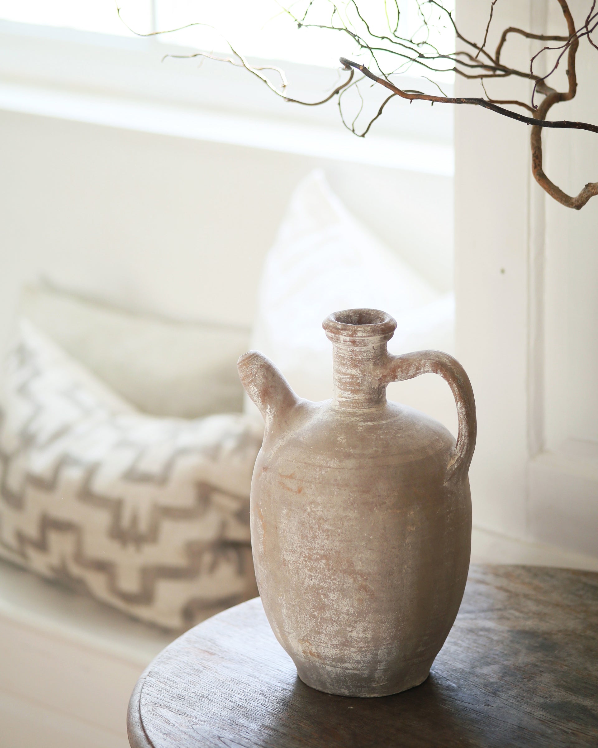 White antique jug with handle and spout