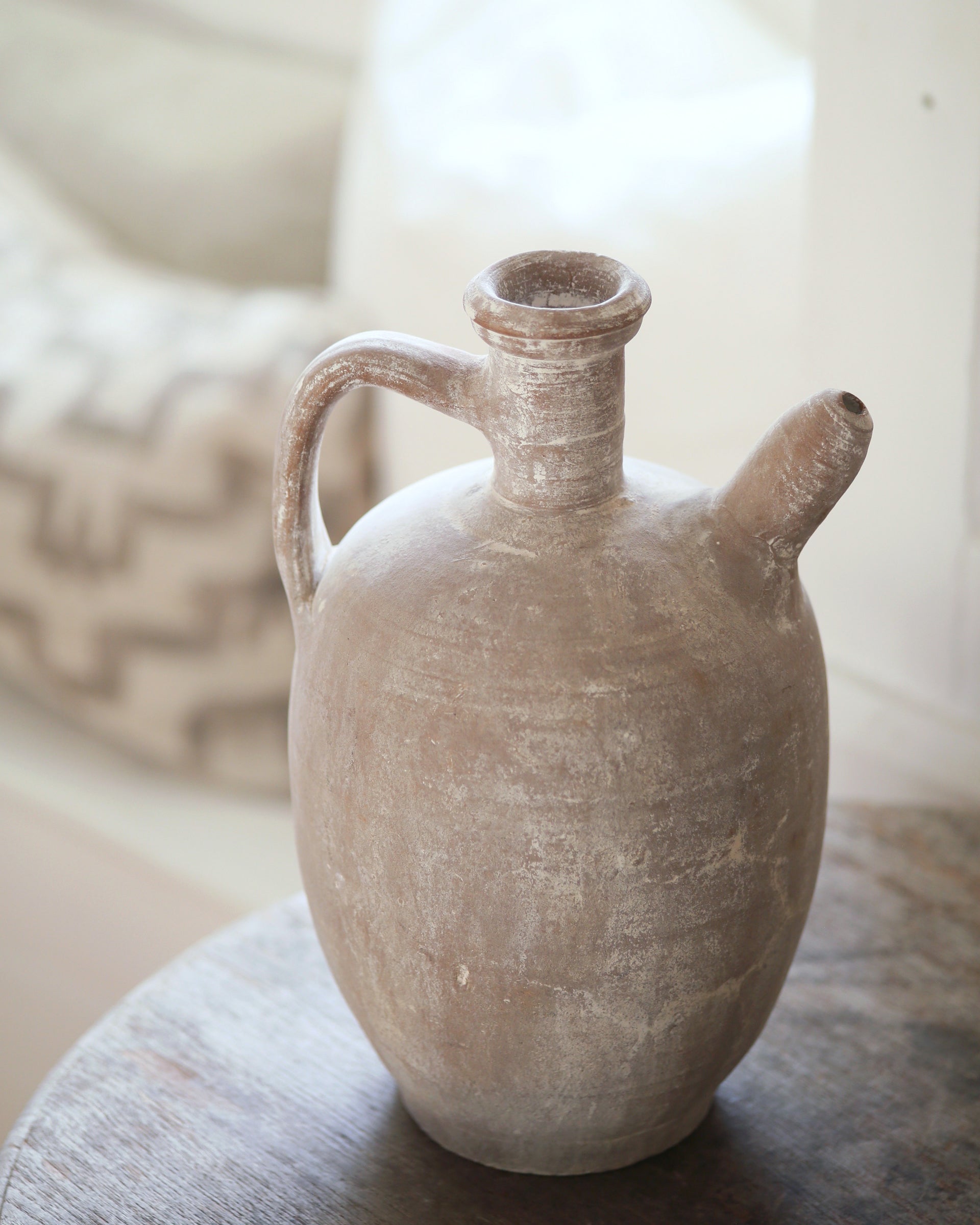 Antique white clay jug with spout