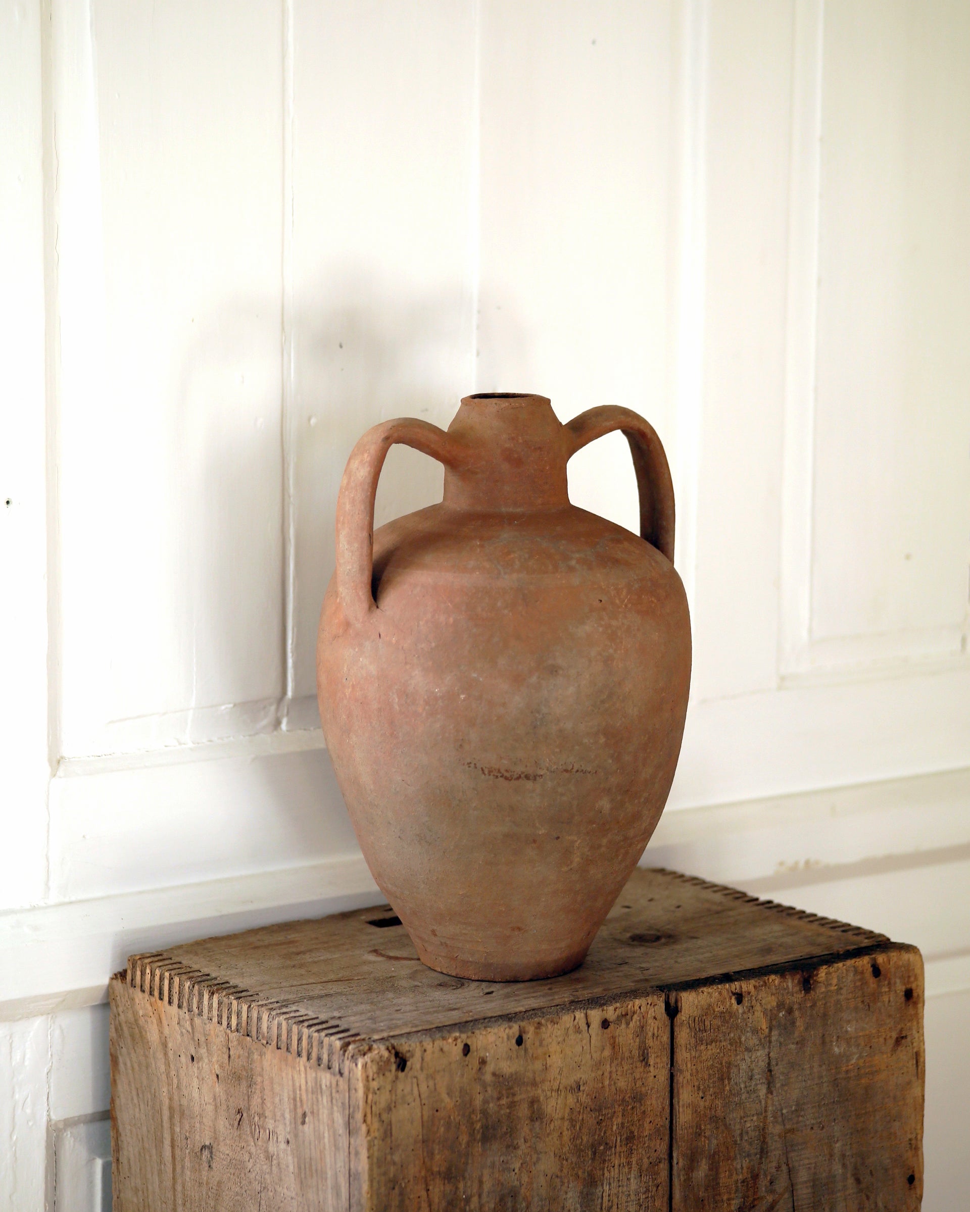 Statement antique urn on wooden plinth