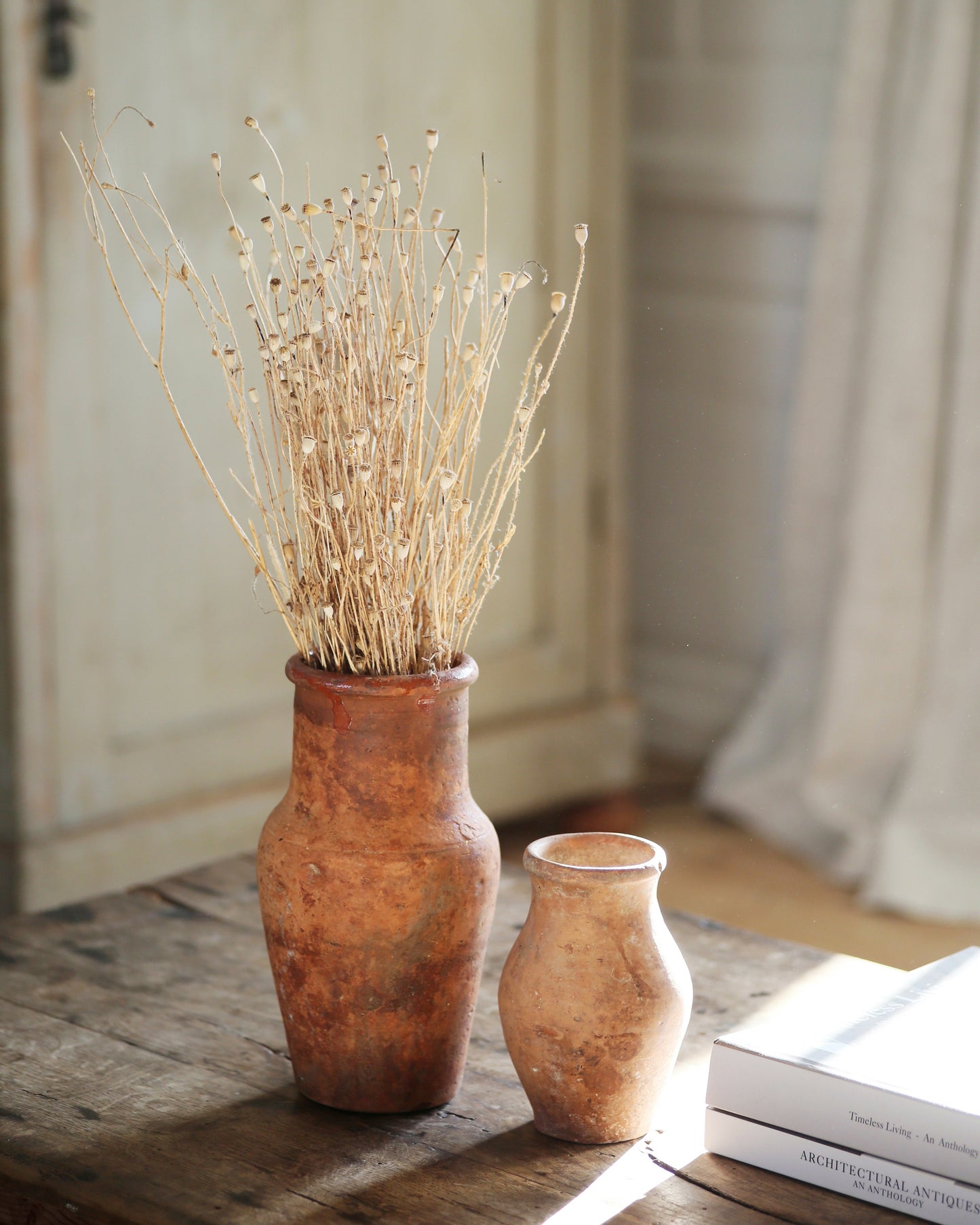 Two vintage textured terracotta vases on coffee table