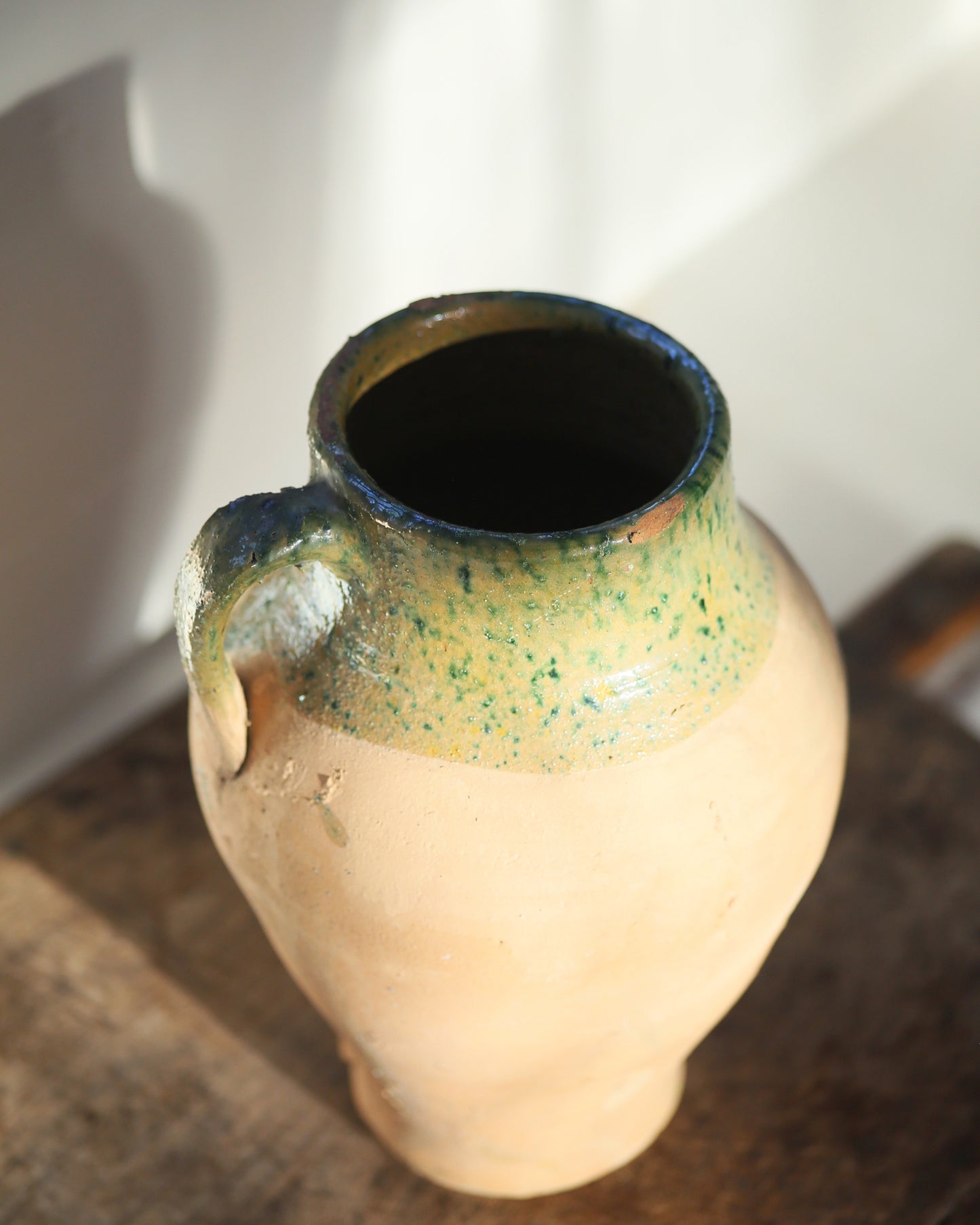 Textured detail and condition of antique terracotta pitcher pot