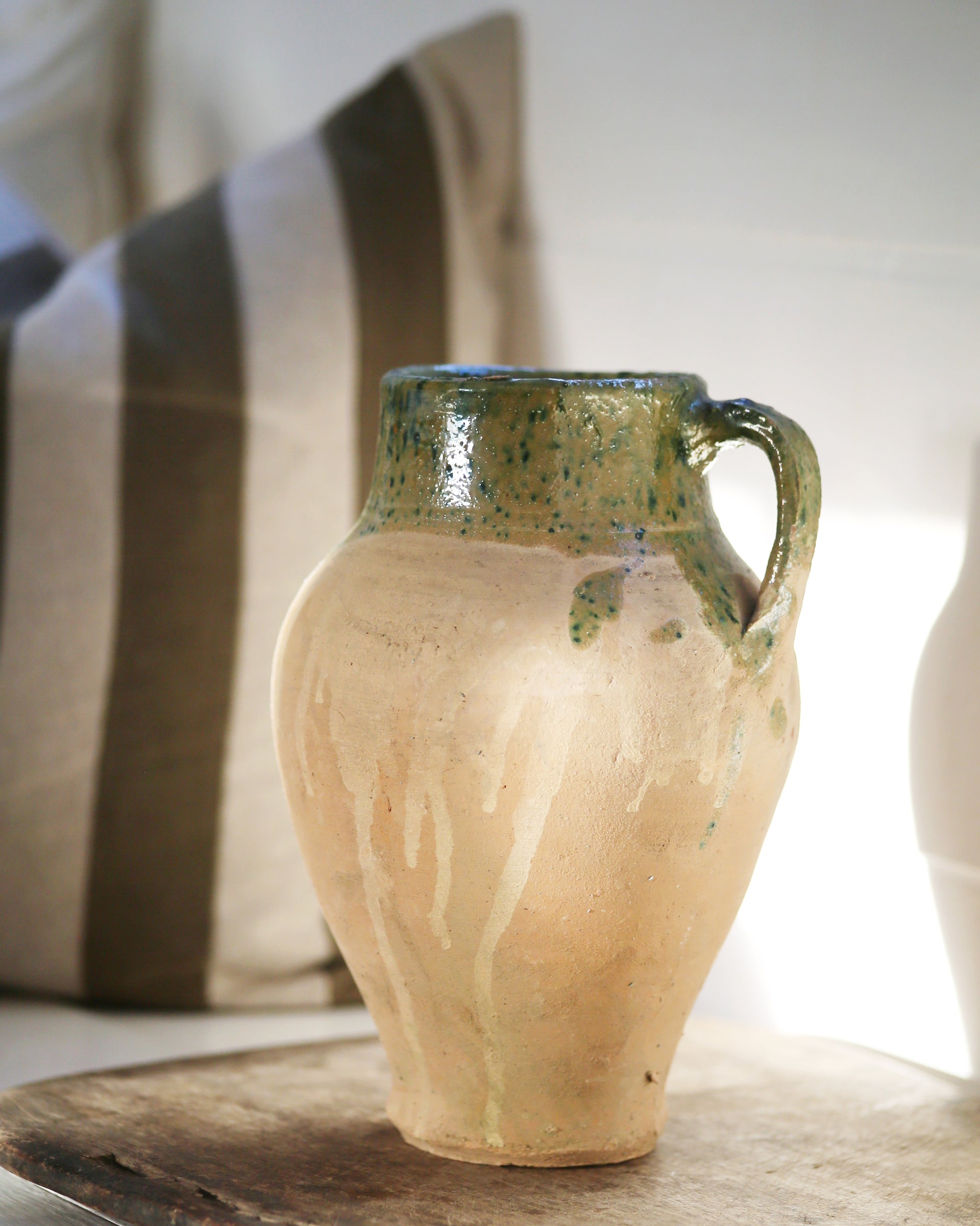 Antique clay pitcher jug with green glazed detail