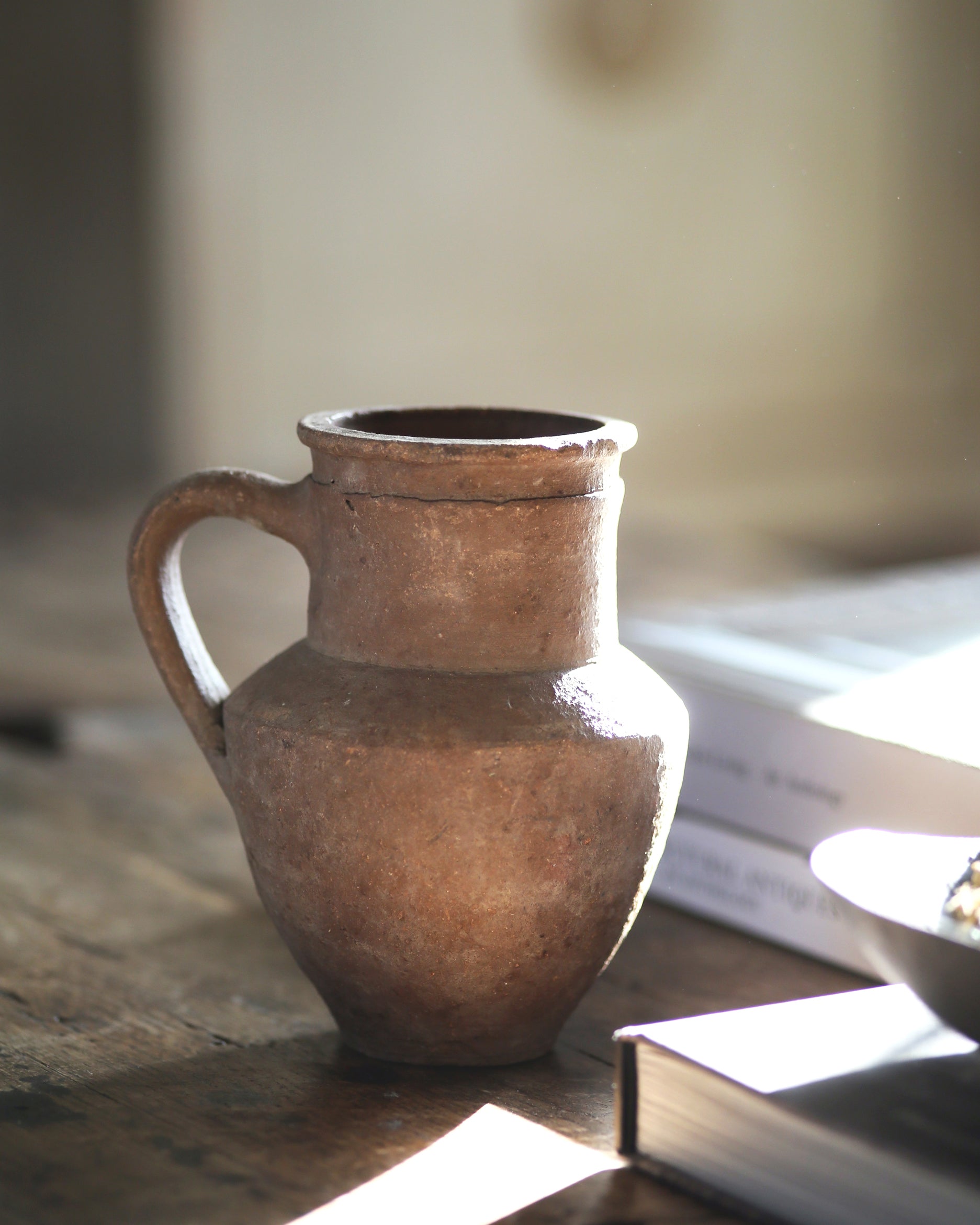Rustic textured antique jug with handle