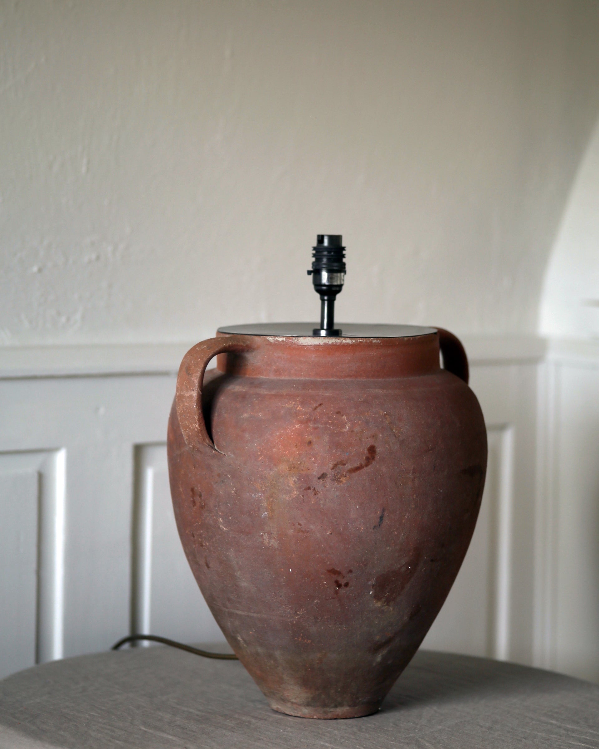 Antique authentically aged patina of terracotta pot surface and brassware light fittings