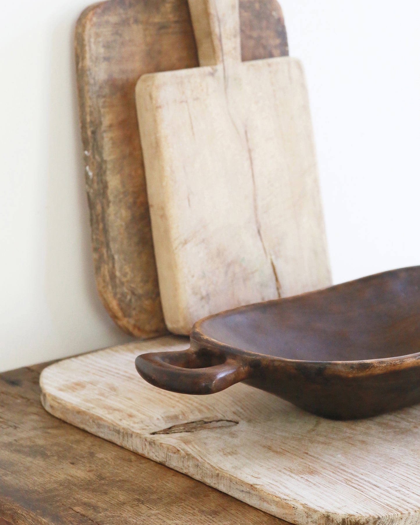 Handle detail on rustic wooden serving bowl with kitchen styling
