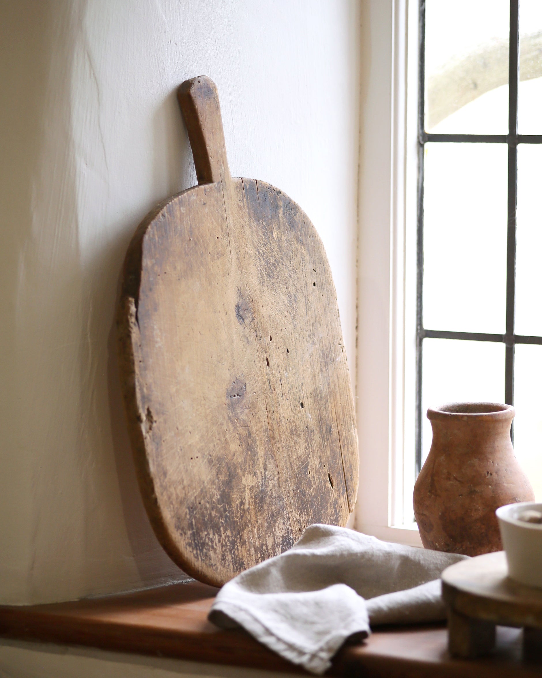Darkened vintage wooden bread board