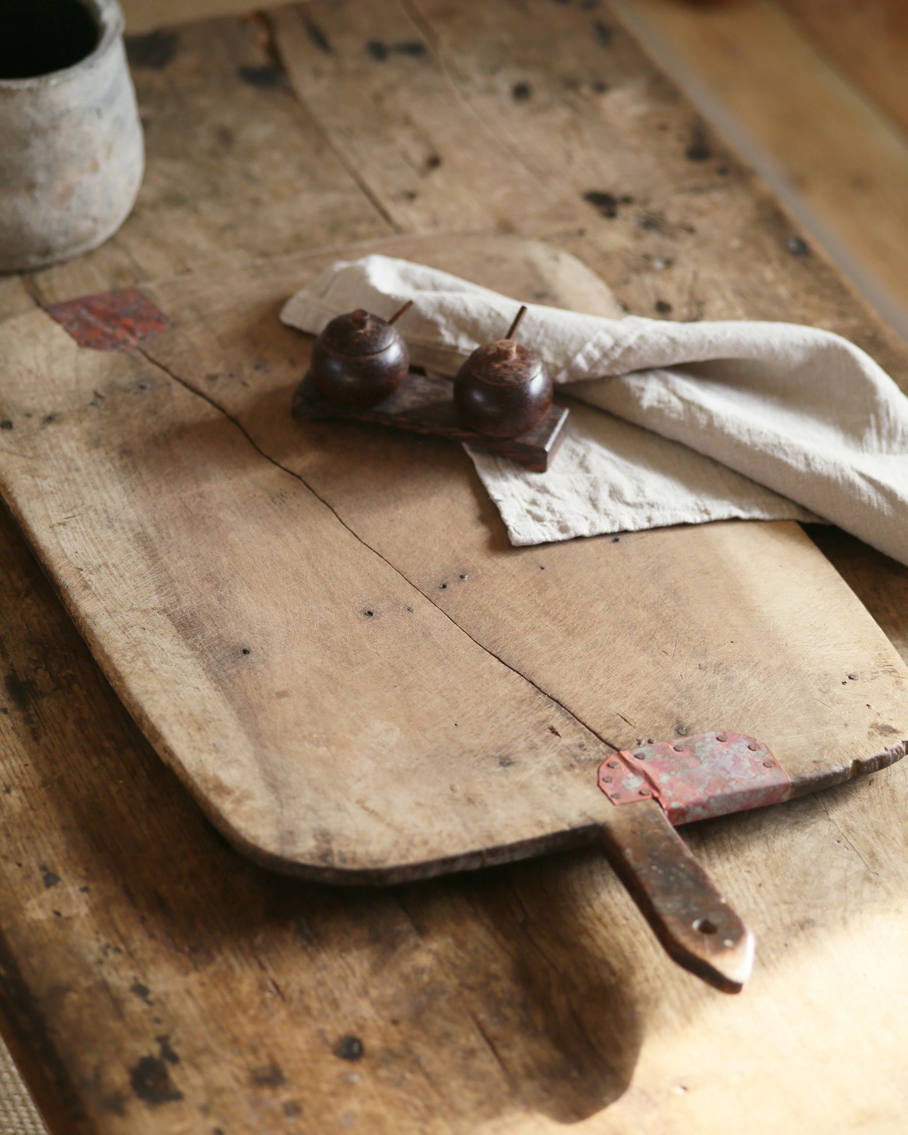 Rustic vintage bread board with copper repair detail