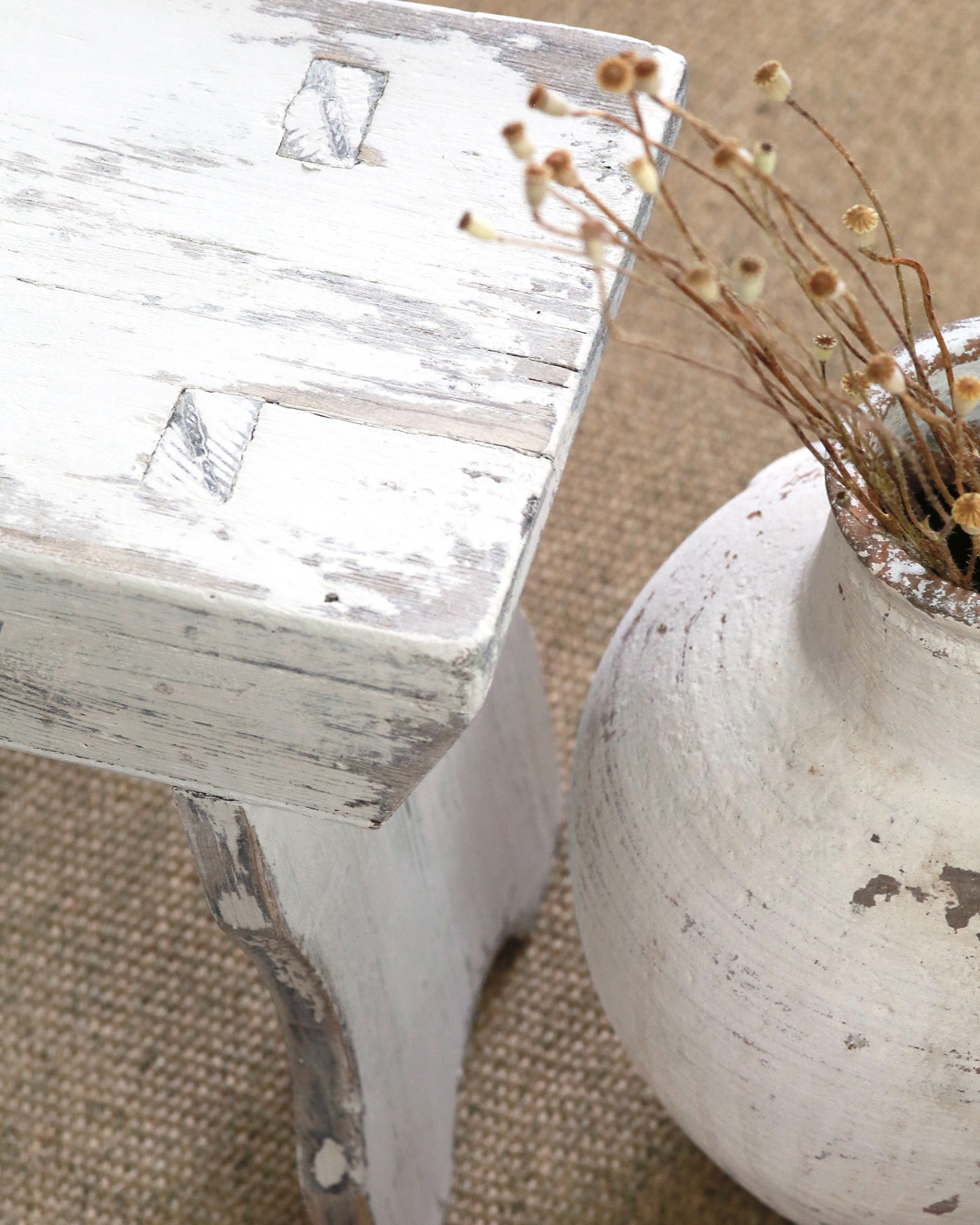 Rustic weathered finish to wood of milking stool