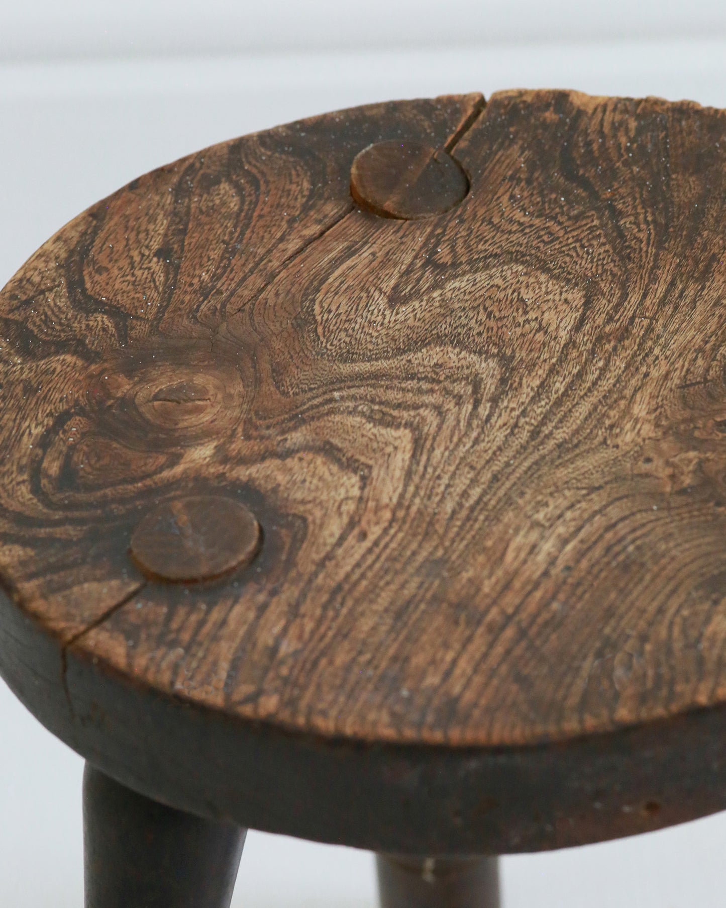 Close up of three legged stool craftsmanship