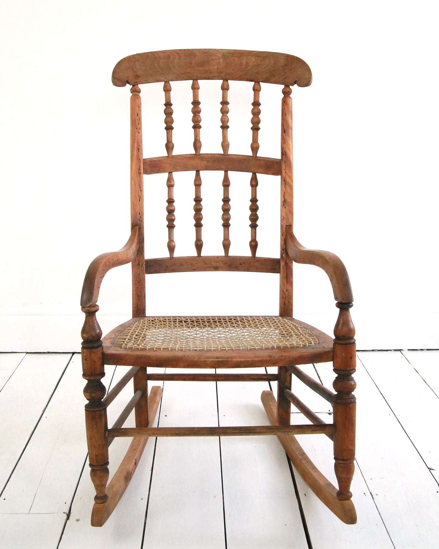 Antique wooden string seat rocking chair